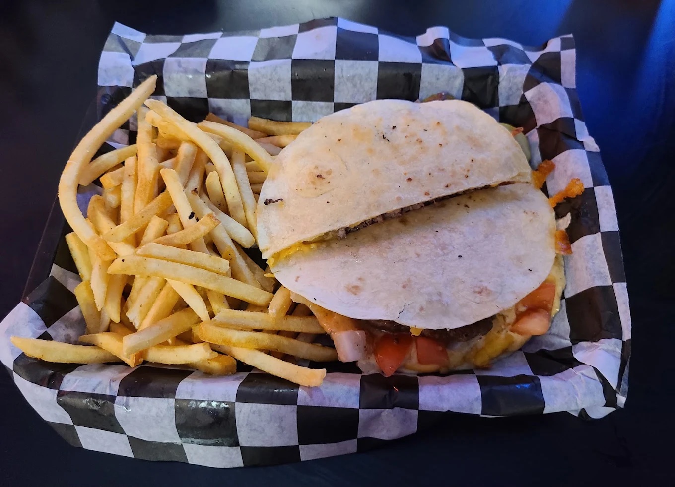 Quesadilla burger with tomatoes and fries