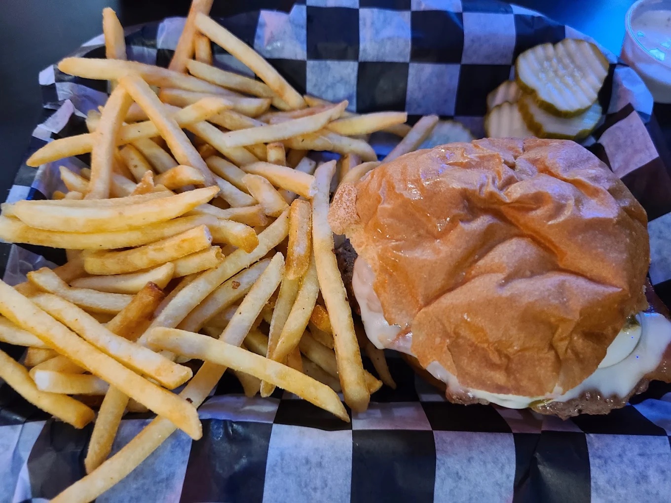 Cheeseburger and fries basket with pickles